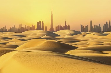 Dubai skyline in desert at sunset